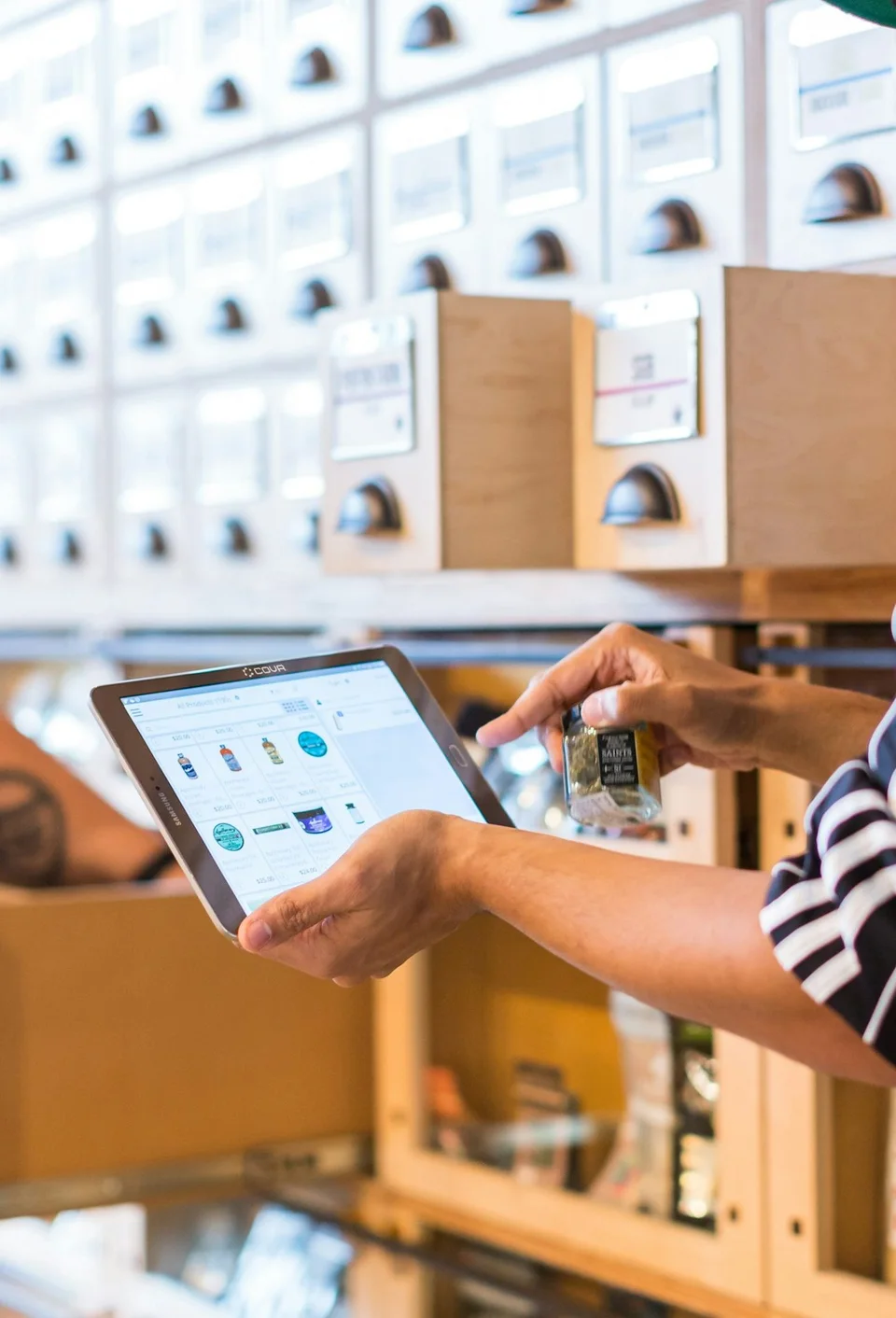 Two team members checking stock on a tablet in a stockroom