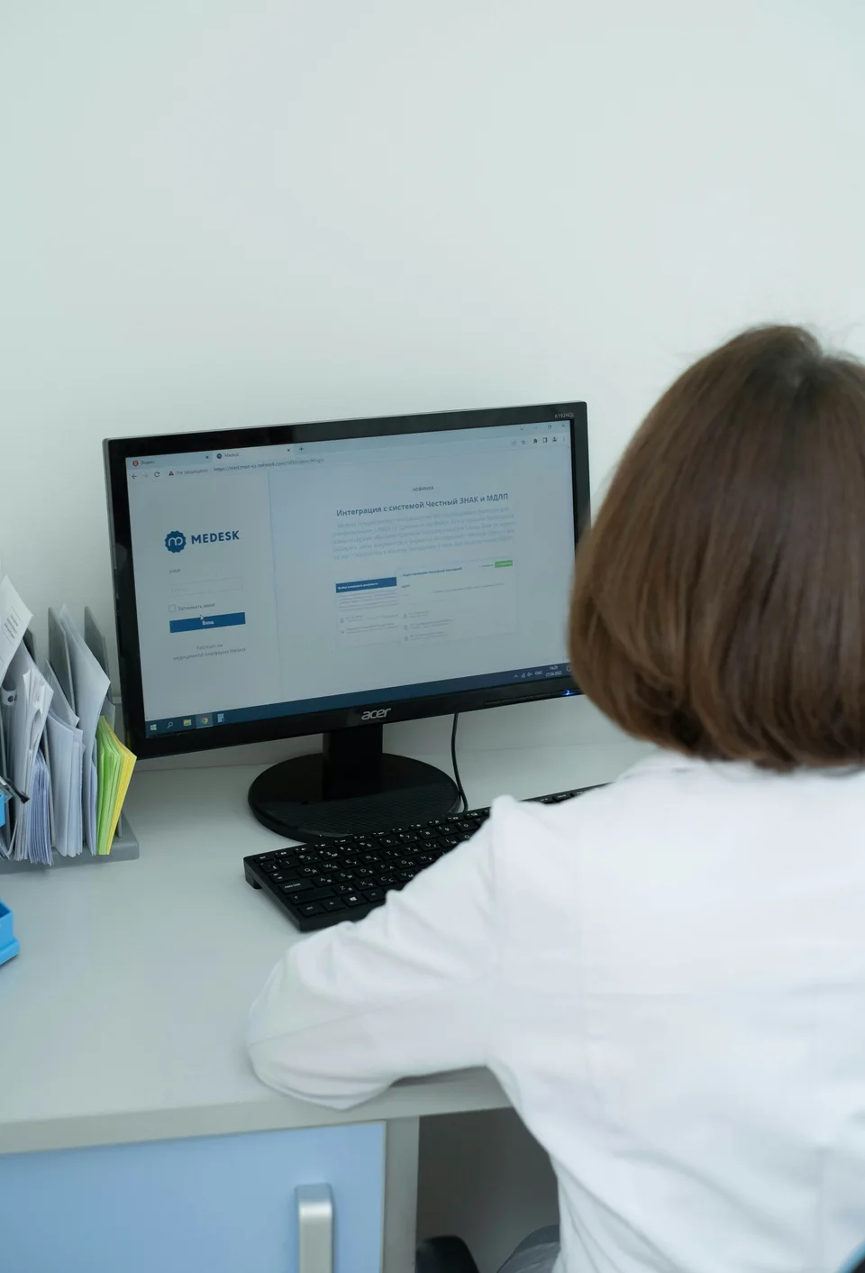 Clinician reviewing a patient system on her desktop